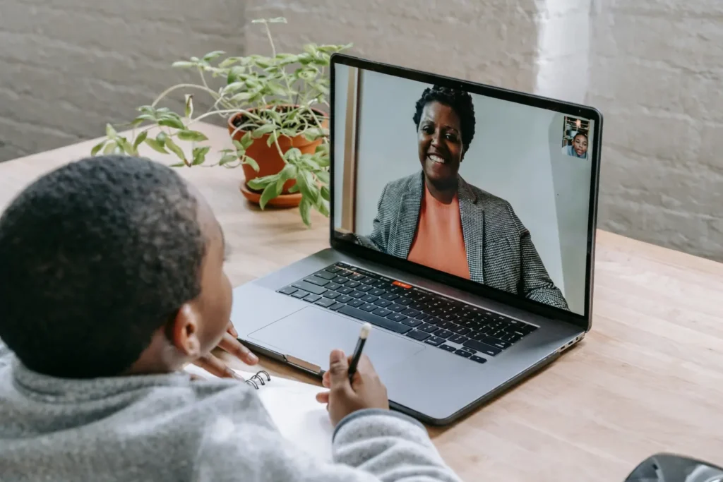 Boy on video call with woman