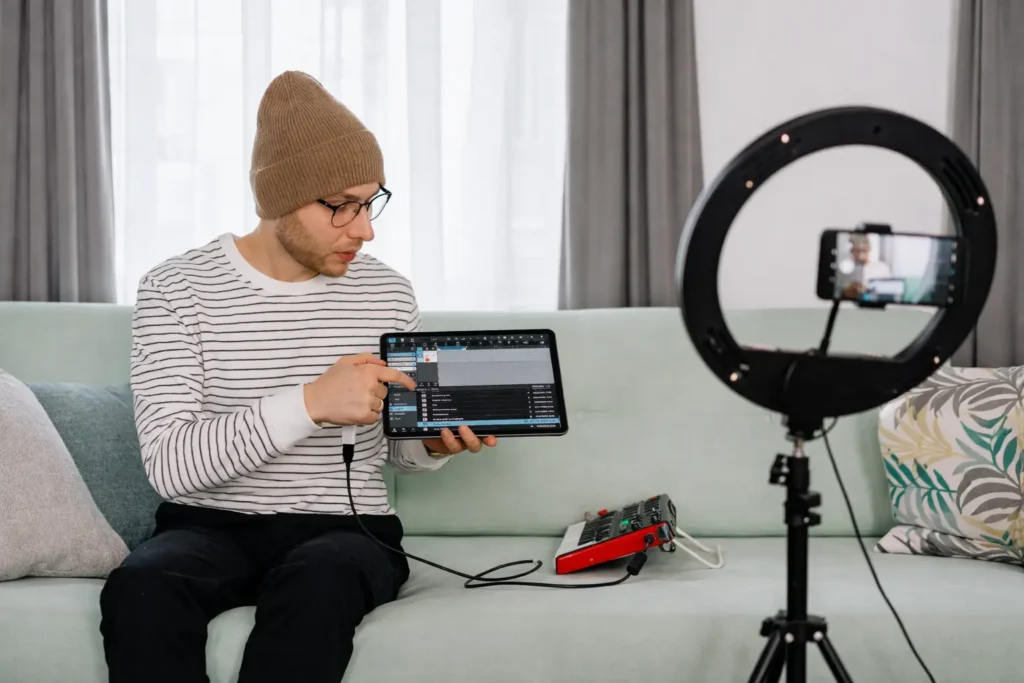 Man recording a tutorial with a tablet and ring light