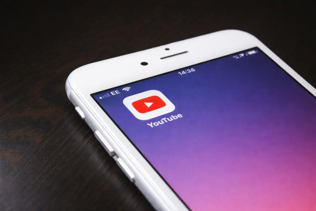 iPhone with YouTube app icon